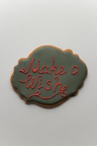 holiday inscription on baked cookie